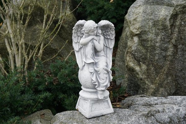 Angels on the pedestal looking left