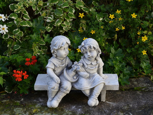 Two children figures on the bench