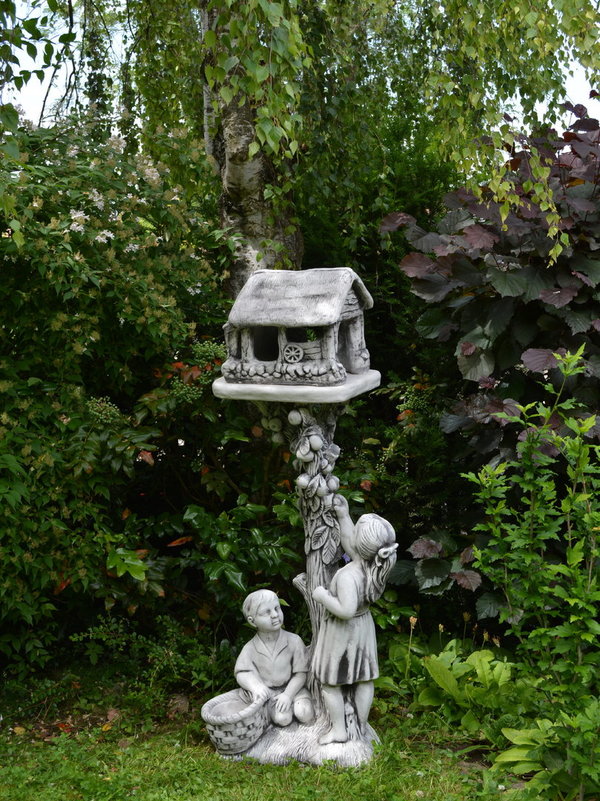 Boy and girl with birdhouse statue