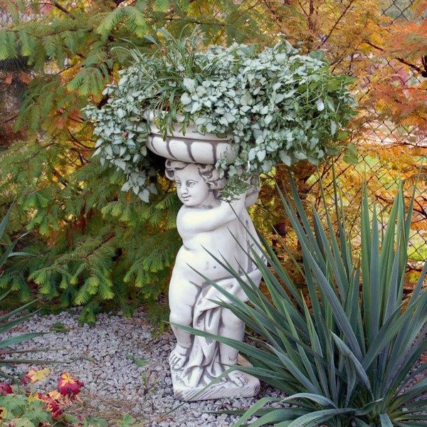 Statue boy with plant bowl left